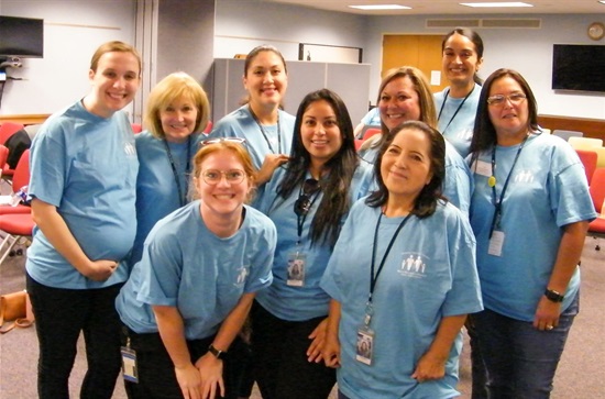 Group Health District staff in blue shirts 