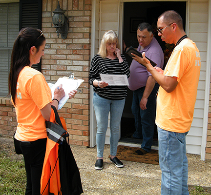 Health District staff going door-to-door conducting the Community Health Needs Assessment Survey.
