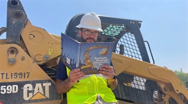 Worker reading next to equipment