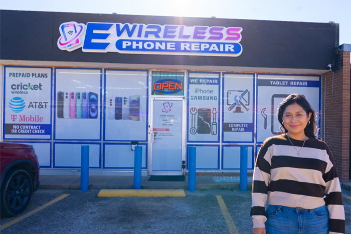A young woman in front of recently remodeled EWireless storefront