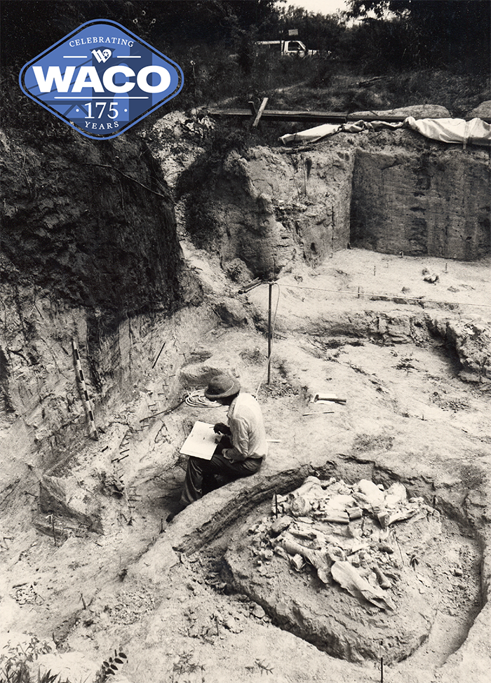 Person taking notes at the mammoth dig site.