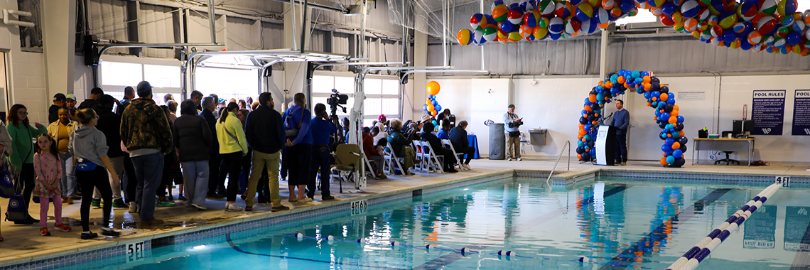 Grand opening of Doris Miller Pool with many people and balloons