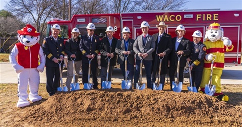 City of Waco and Waco Fire Department officials and Fire Department mascots with the ceremonial groundbreaking shovels in front of a fire truck.