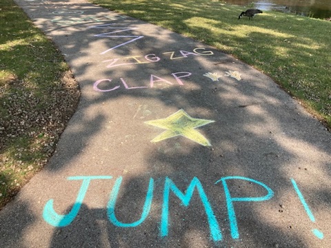 Picture showing a obstacle course drawn in chalk on a sidewalk.