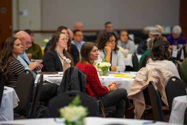 Summit audience sitting at banquet tables