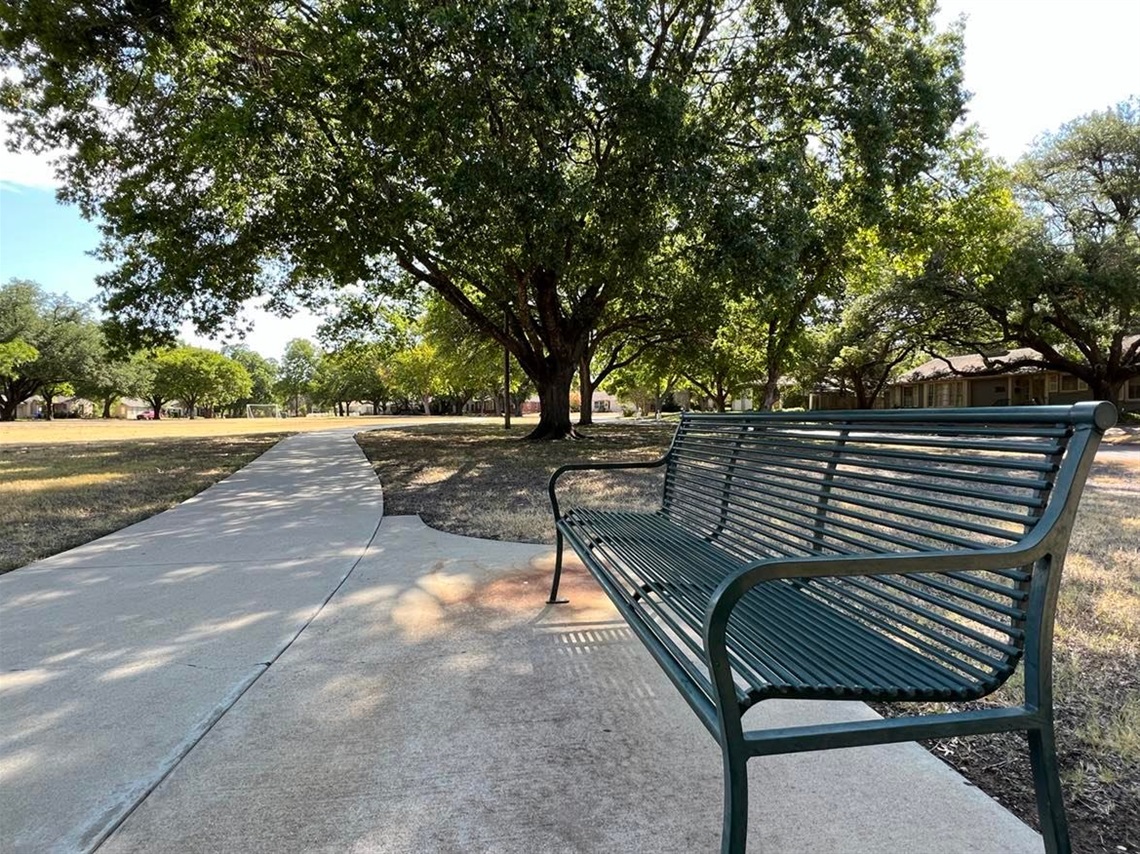 Photo of bench and walking trail at Mitchell Park.