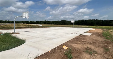 Sport court construction including two basketball hoops at the new China Spring Park.