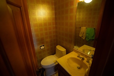 Dimly lit half bathroom