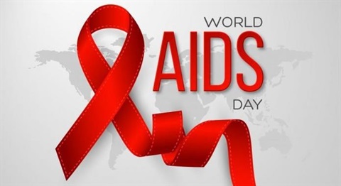 Red ribbon on a grey background with World AIDS Day in text