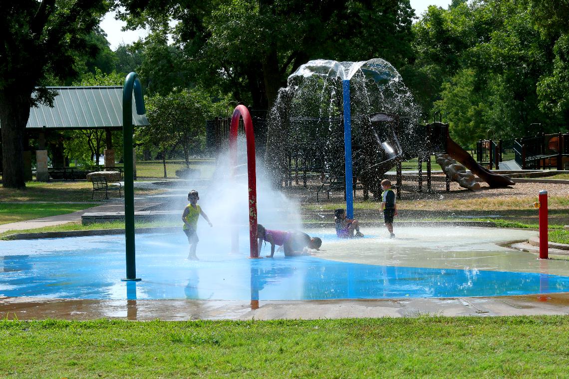 Photo of kids playing in the splash pad at Pecan Bottoms.